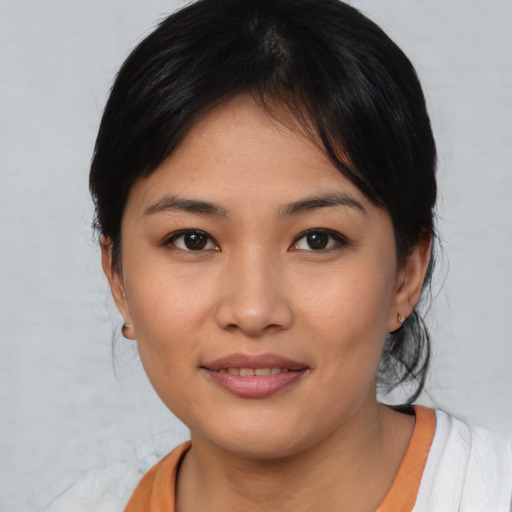 Joyful asian young-adult female with medium  black hair and brown eyes