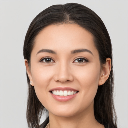 Joyful white young-adult female with long  brown hair and brown eyes