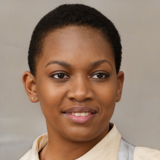 Joyful black young-adult female with short  brown hair and brown eyes