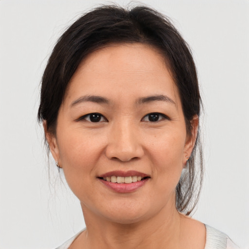 Joyful asian young-adult female with medium  brown hair and brown eyes