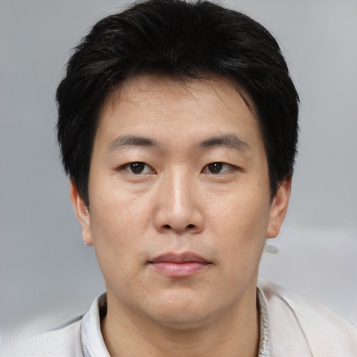 Neutral asian young-adult male with short  brown hair and brown eyes