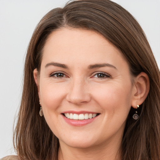 Joyful white young-adult female with long  brown hair and grey eyes