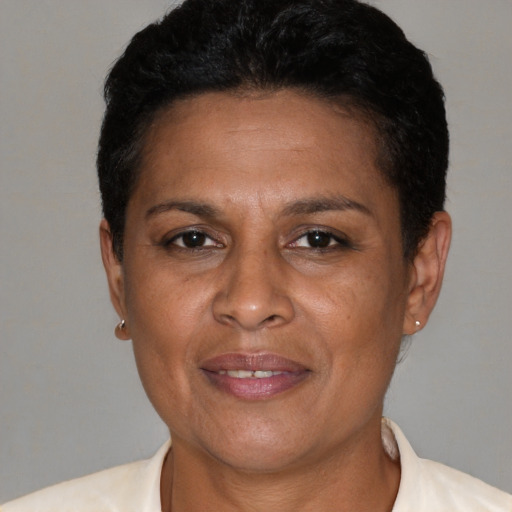 Joyful latino adult female with short  brown hair and brown eyes