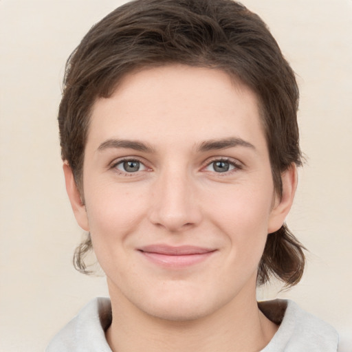 Joyful white young-adult female with short  brown hair and grey eyes