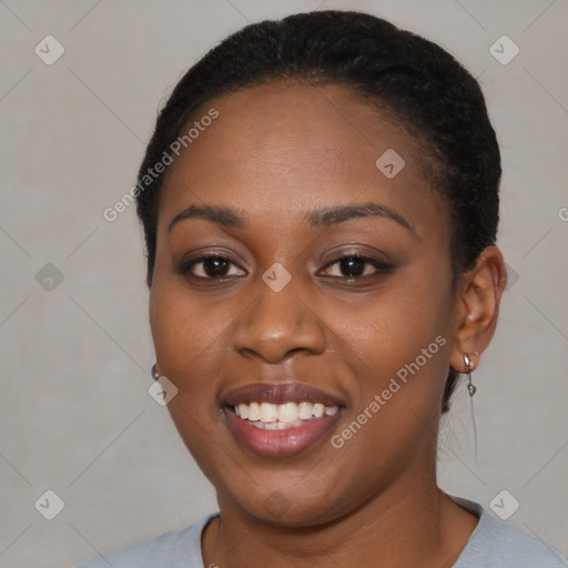 Joyful black young-adult female with short  black hair and brown eyes