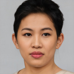 Joyful asian young-adult female with short  black hair and brown eyes