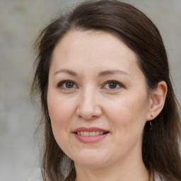 Joyful white adult female with medium  brown hair and brown eyes