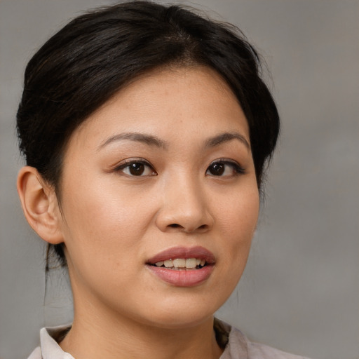 Joyful asian young-adult female with medium  brown hair and brown eyes