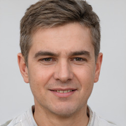 Joyful white adult male with short  brown hair and brown eyes