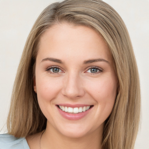 Joyful white young-adult female with long  brown hair and blue eyes