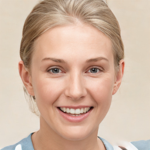 Joyful white young-adult female with medium  blond hair and grey eyes