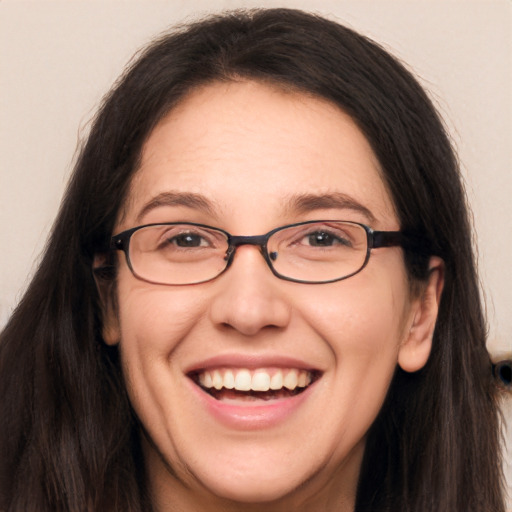 Joyful white adult female with long  brown hair and brown eyes