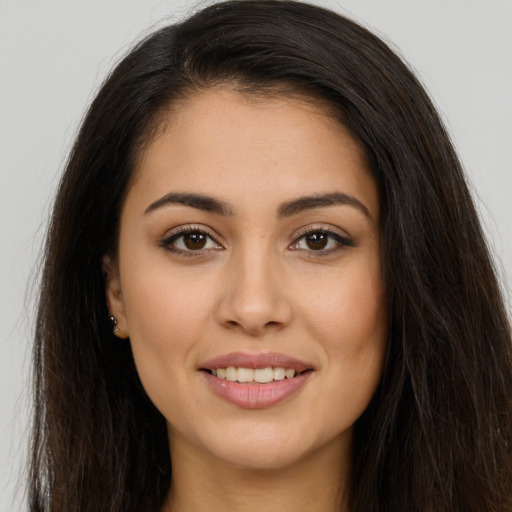 Joyful white young-adult female with long  brown hair and brown eyes