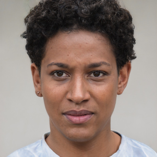 Joyful black young-adult female with short  brown hair and brown eyes