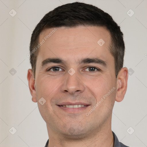 Joyful white young-adult male with short  brown hair and brown eyes