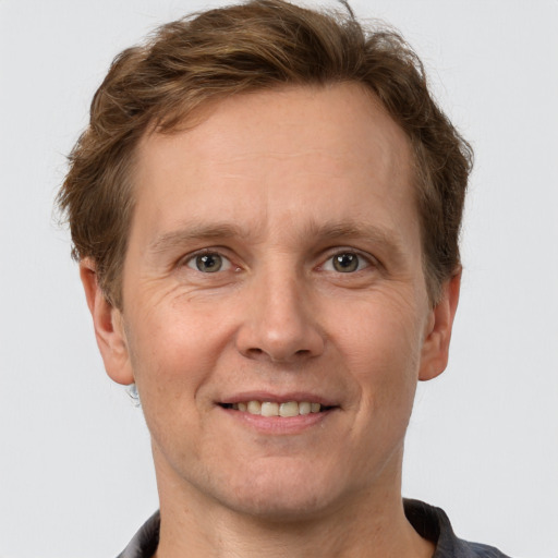 Joyful white adult male with short  brown hair and grey eyes