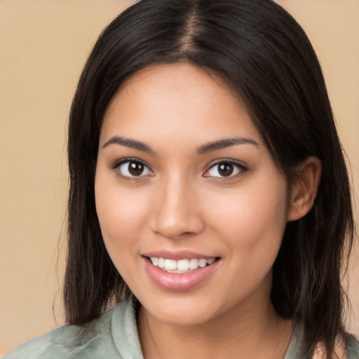 Joyful white young-adult female with long  brown hair and brown eyes