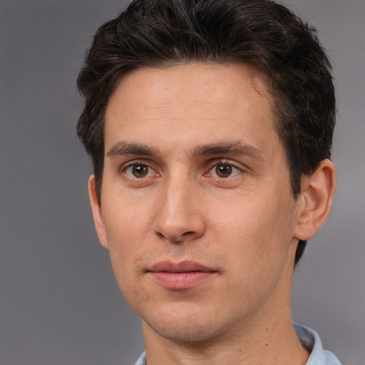 Joyful white adult male with short  brown hair and brown eyes