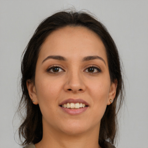 Joyful white young-adult female with medium  brown hair and brown eyes