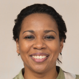 Joyful black adult female with short  brown hair and brown eyes