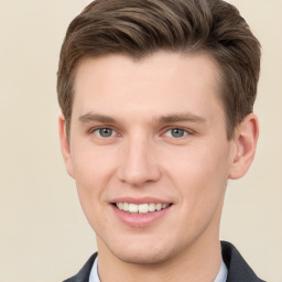 Joyful white young-adult male with short  brown hair and grey eyes