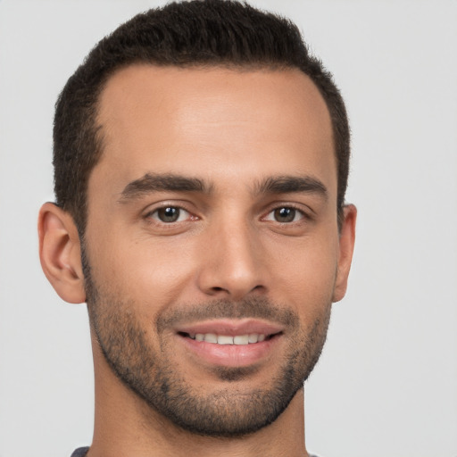 Joyful white young-adult male with short  brown hair and brown eyes