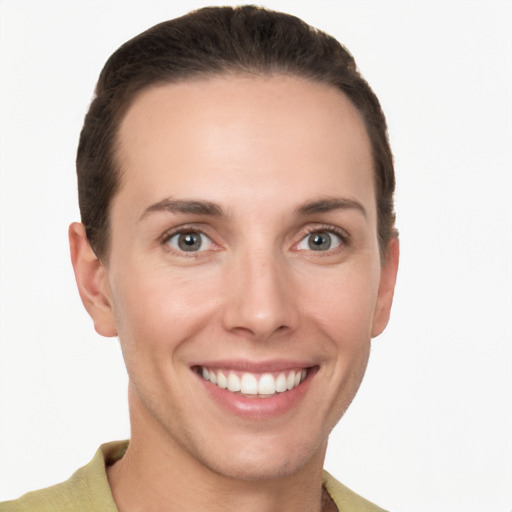 Joyful white young-adult female with short  brown hair and grey eyes