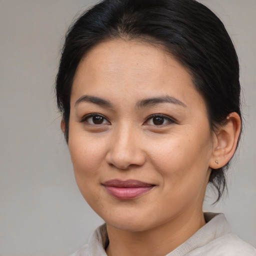 Joyful asian young-adult female with medium  brown hair and brown eyes