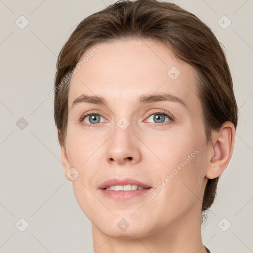 Joyful white young-adult female with short  brown hair and grey eyes