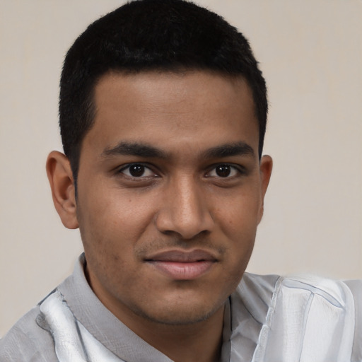 Joyful latino young-adult male with short  black hair and brown eyes