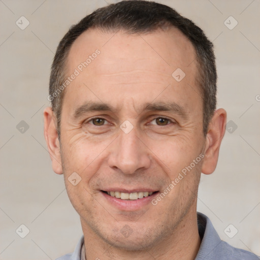 Joyful white adult male with short  brown hair and brown eyes