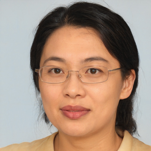 Joyful asian adult female with medium  brown hair and brown eyes