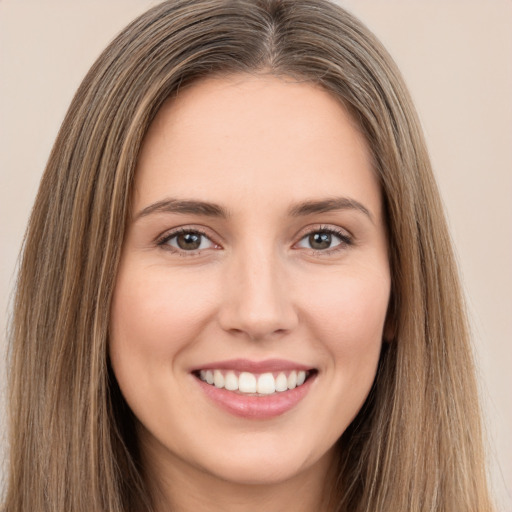 Joyful white young-adult female with long  brown hair and brown eyes