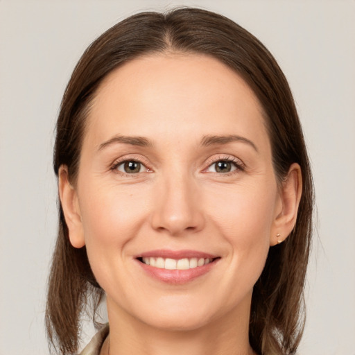 Joyful white young-adult female with medium  brown hair and brown eyes