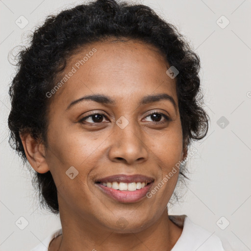 Joyful black adult female with short  brown hair and brown eyes