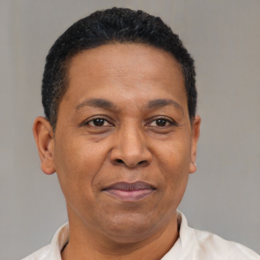 Joyful latino adult male with short  brown hair and brown eyes