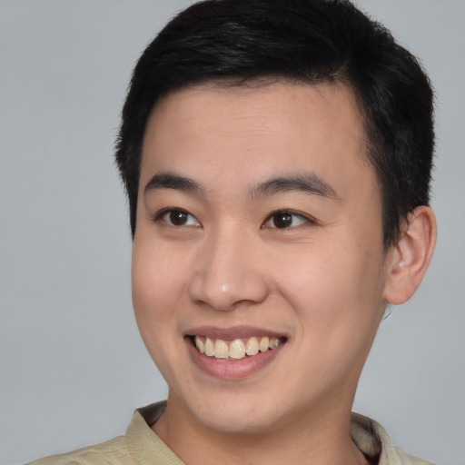 Joyful asian young-adult male with short  brown hair and brown eyes