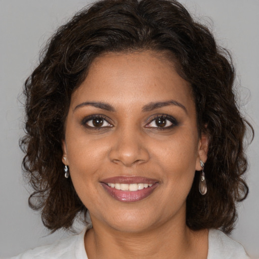 Joyful black young-adult female with medium  brown hair and brown eyes