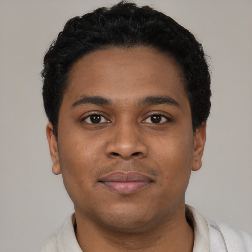 Joyful latino young-adult male with short  brown hair and brown eyes