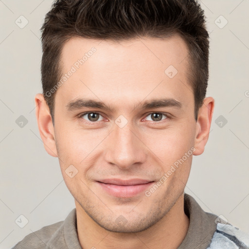 Joyful white young-adult male with short  brown hair and brown eyes