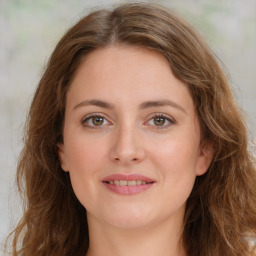 Joyful white young-adult female with long  brown hair and green eyes