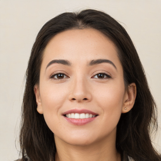 Joyful white young-adult female with long  brown hair and brown eyes