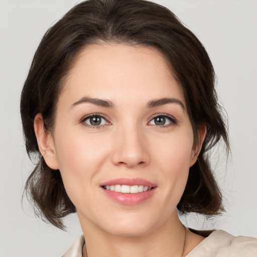 Joyful white young-adult female with medium  brown hair and brown eyes