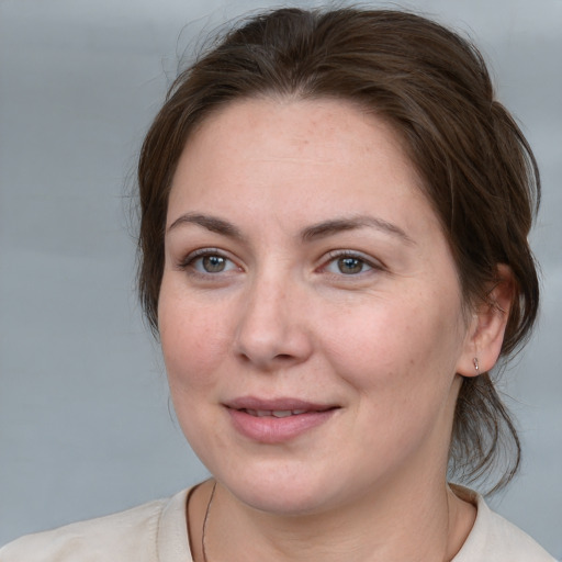 Joyful white adult female with medium  brown hair and brown eyes