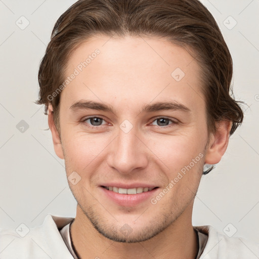 Joyful white young-adult male with short  brown hair and grey eyes