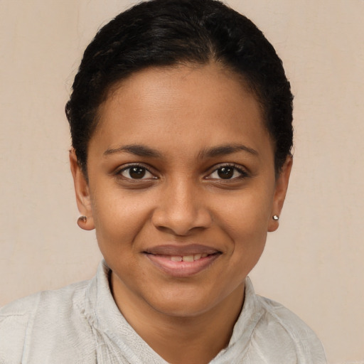 Joyful black young-adult female with short  brown hair and brown eyes