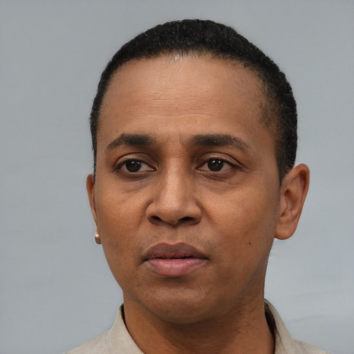 Neutral latino adult male with short  black hair and brown eyes