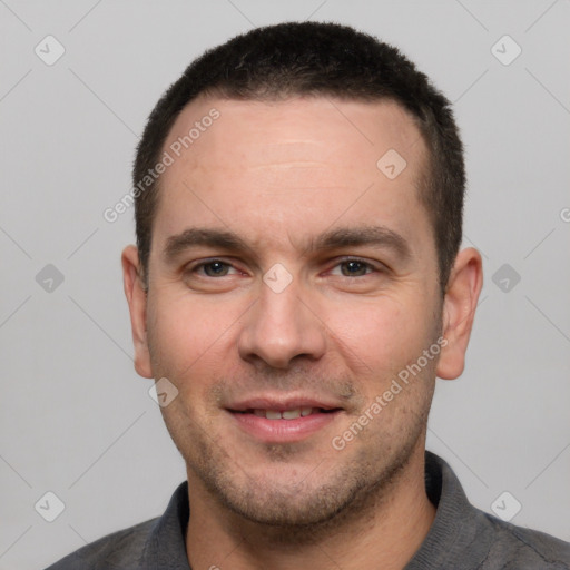 Joyful white young-adult male with short  black hair and brown eyes