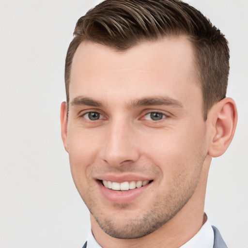 Joyful white young-adult male with short  brown hair and brown eyes