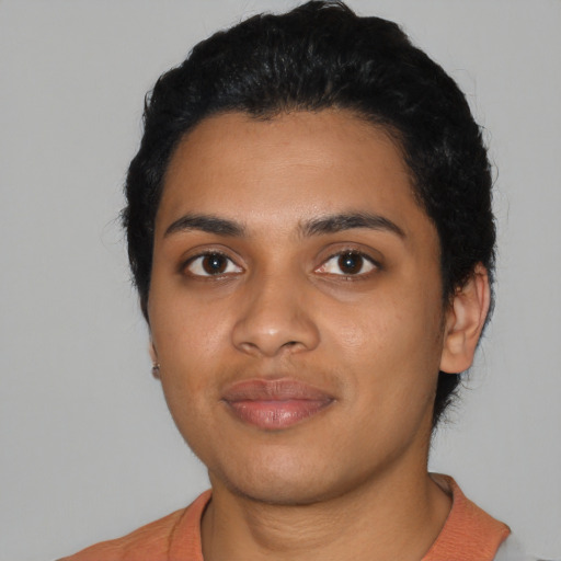 Joyful latino young-adult female with short  black hair and brown eyes